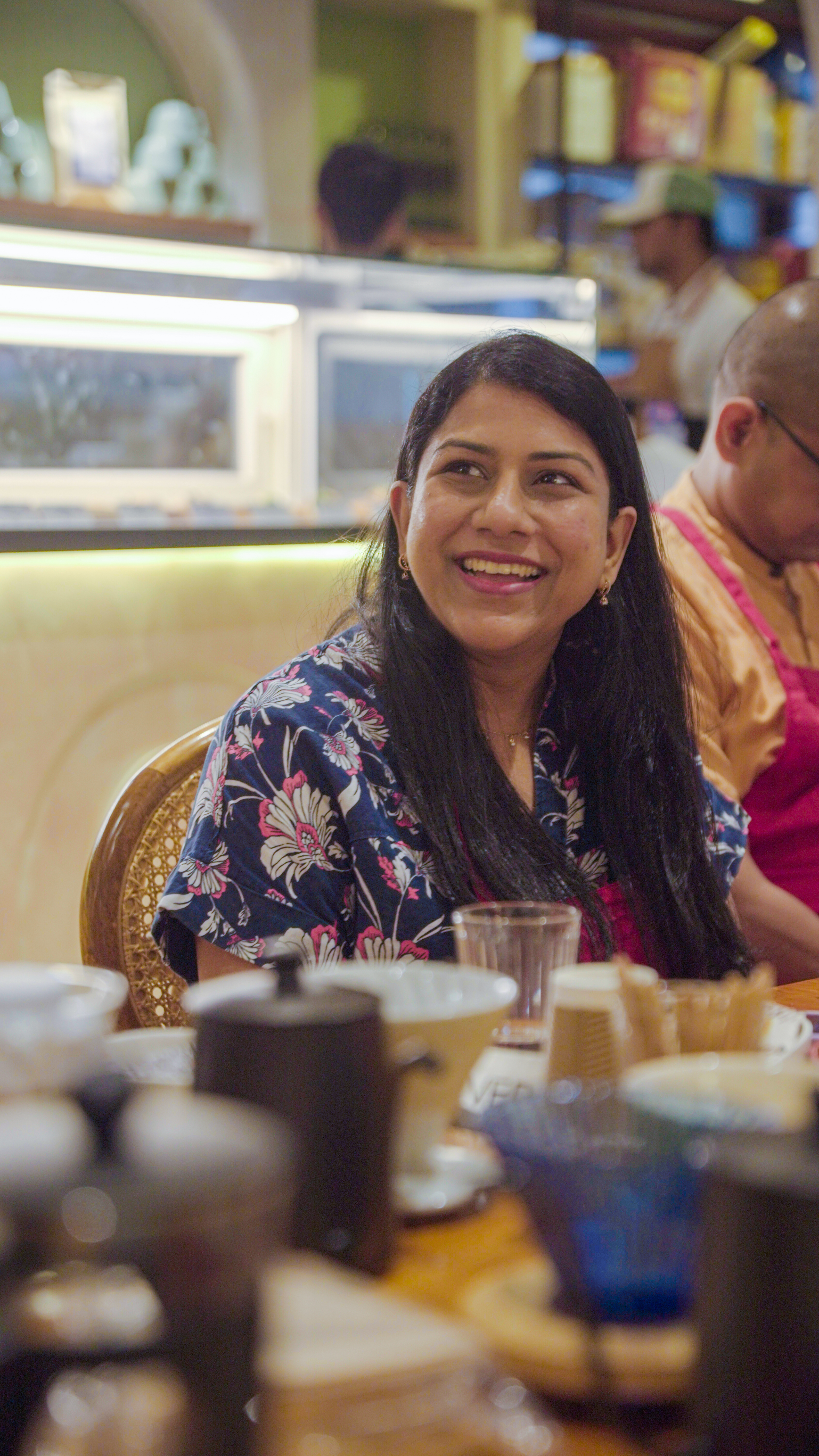 Happy woman enjoying the coffee tasting experience in a cozy setting.